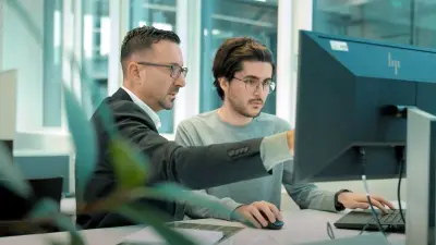 Two engineers collaborating on PCB design using DFM principles at copperdot, emphasizing advanced design for manufacturing techniques.